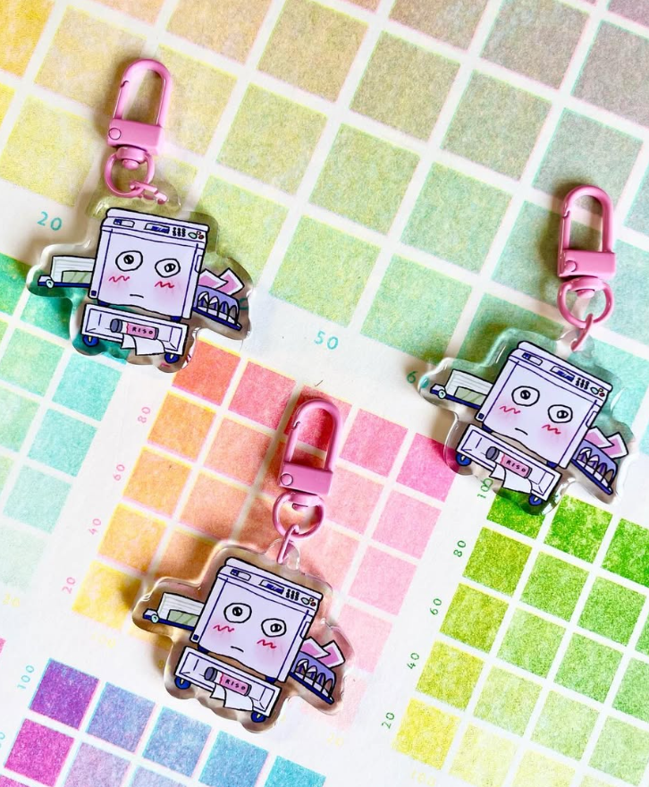 Three printer shaped keychains with pink clips